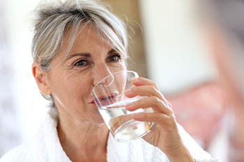 woman drinking a glass of water