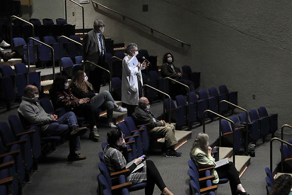 people sitting in an uncrowded auditorium