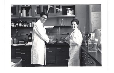a man and woman standing in a lab