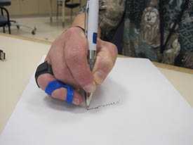 splinted hand using a pen to write