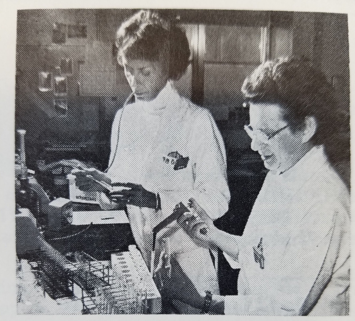 scientists Clara Hall (left) and Dr. Elizabeth Neufeld (right) working in the lab