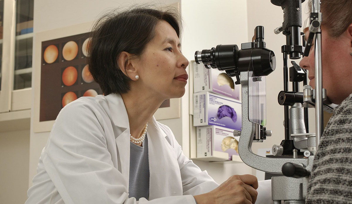 Dr. Emily Chew (left) examining the eyes of a patient
