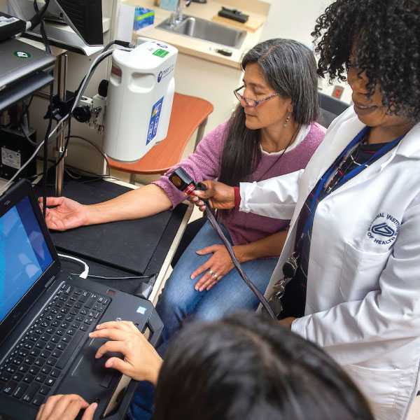 researcher applying thermal stimulation to a volunteer