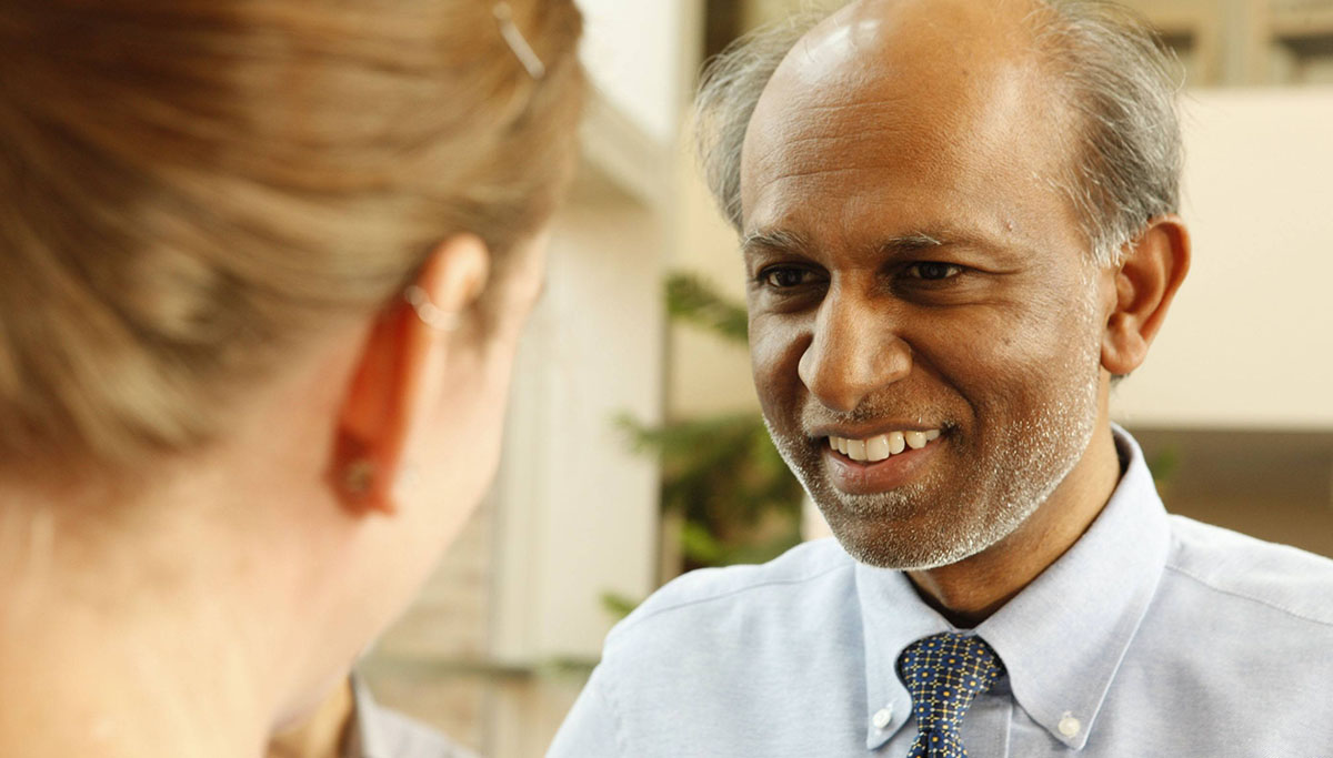 Dr. Avindra Nath talks to a patient