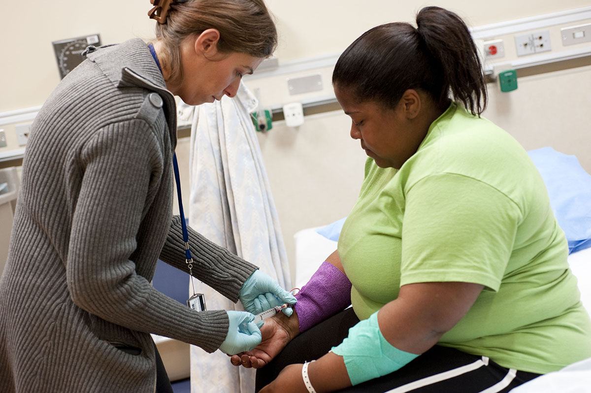 patient with obesity being treated by a nurse