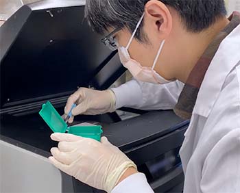 man working at a digital imaging machine