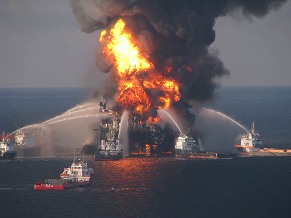 Deep Water Horizon oil rig on fire with coast guard attempting to out the flames
