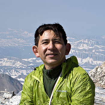 man with snow-covered mountains in background