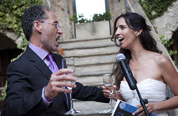 man and woman singing to each other at their wedding