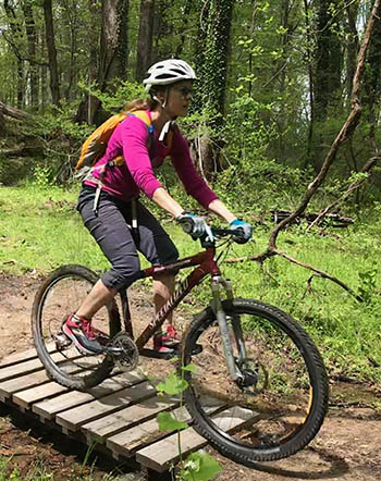 woman on bike in the woods