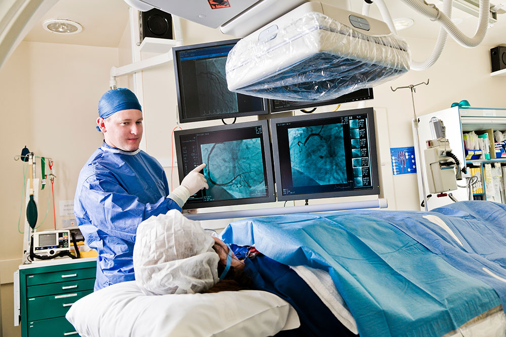 a doctor discusses scans with a patient undergoing a procedure