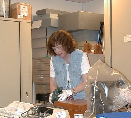 a museum curator examining objects