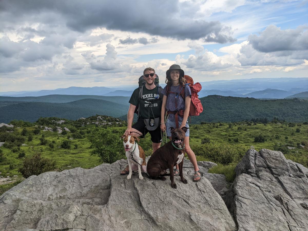 Dr. Ayland Letsinger with his wife and dogs on a mountain hike
