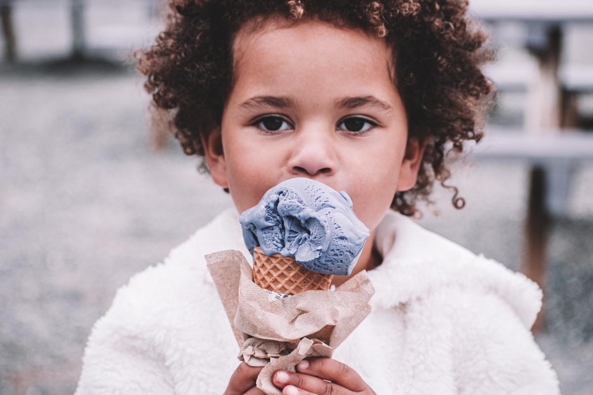 child licking ice cream cone