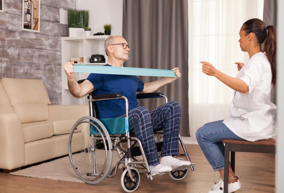 man in wheelchair doing physical therapy