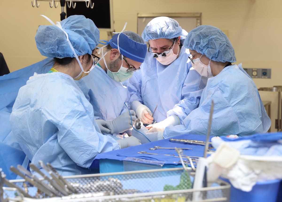 Surgeons in blue scrubs in the operating room