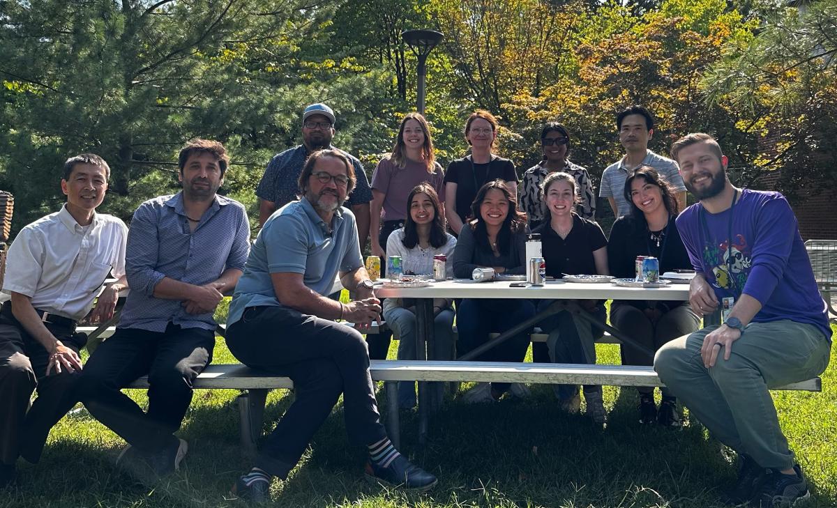 Lab team of John Tisdale sitting around a picnic table
