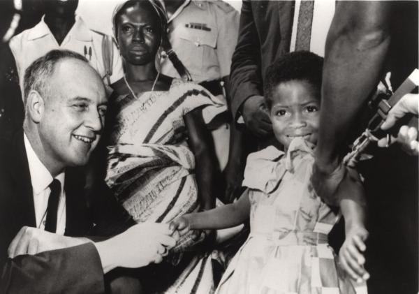 Surgeon General William Stewart poses with Rebecca Ansah Asamoah as she receives the 25-millionth smallpox vaccination