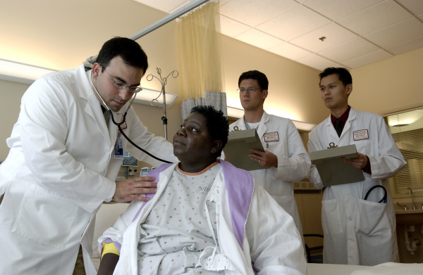doctor examining African American patient