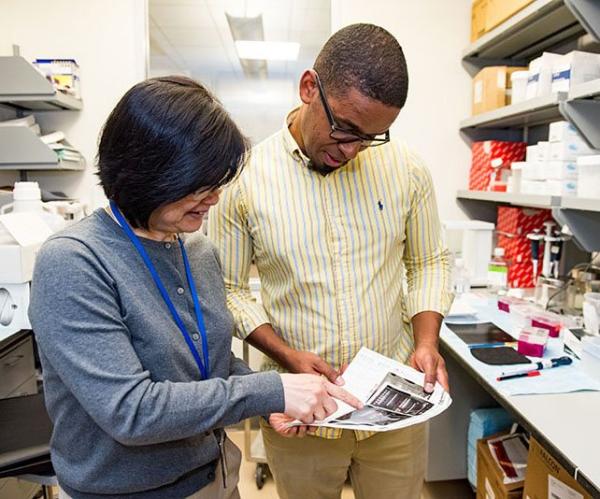 Dr. Mario Penzo (right) reviewed experimental results with Dr. Yan Leng, his staff scientist and lab manager