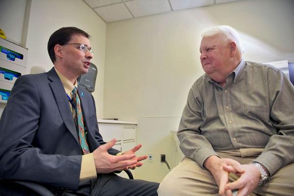 Dr. James Gulley talking with a patient