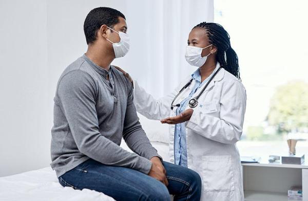 African American patient talking with doctor