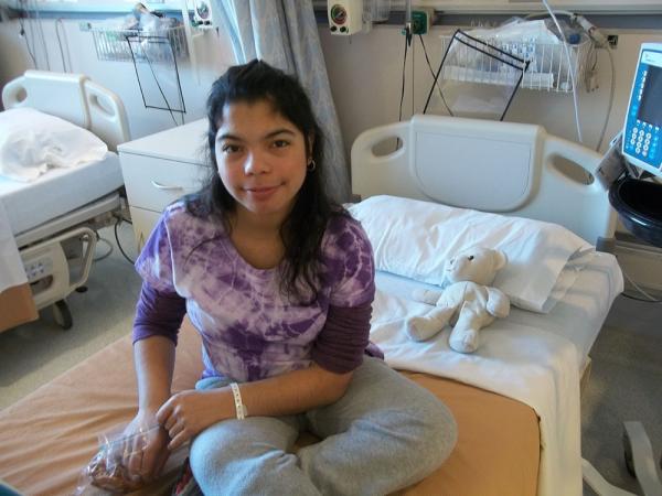 NIH research participant Noah Victoria in a patient room at the NIH Clinical Center