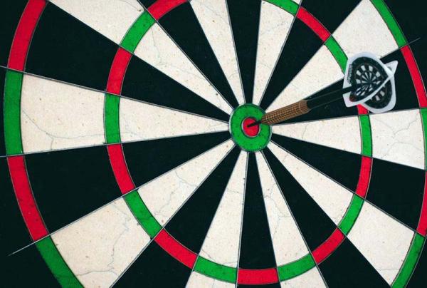dartboard with dart in the bullseye