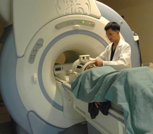 research volunteer going into functional magnetic resonance imaging machine