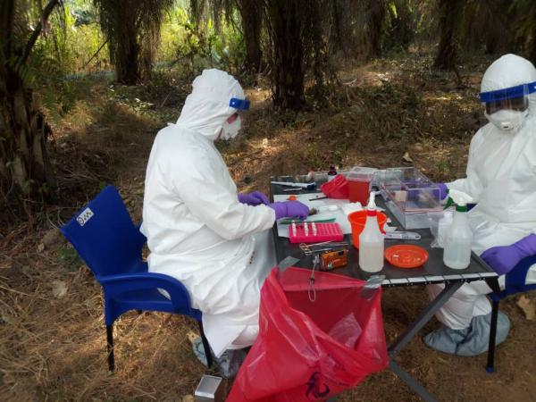 two people in hazmat suits sitting at table
