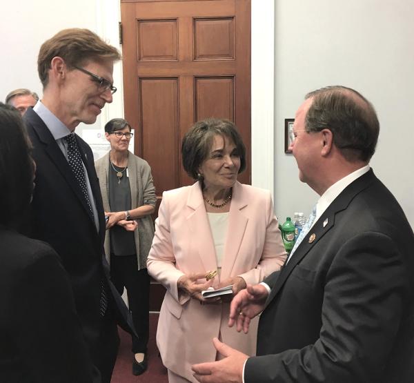 Dr. Bruce Tromberg (left) chats with Rep. Anna Eshoo of California (middle) and then-Rep. Bill Flores of Texas (right)