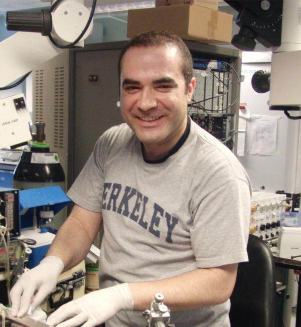 Dr. Shahriar SheikhBahaei working in the lab wearing a UC Berkeley shirt
