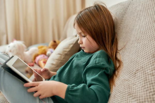 little girl playing on a tablet