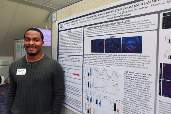 IRP postbac fellow Vernon Kennedy with his poster at Postbac Poster Day