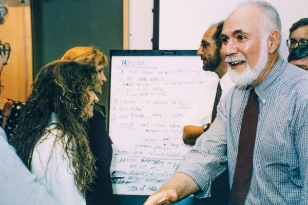 Harold Slavkin shaking hands with a colleague