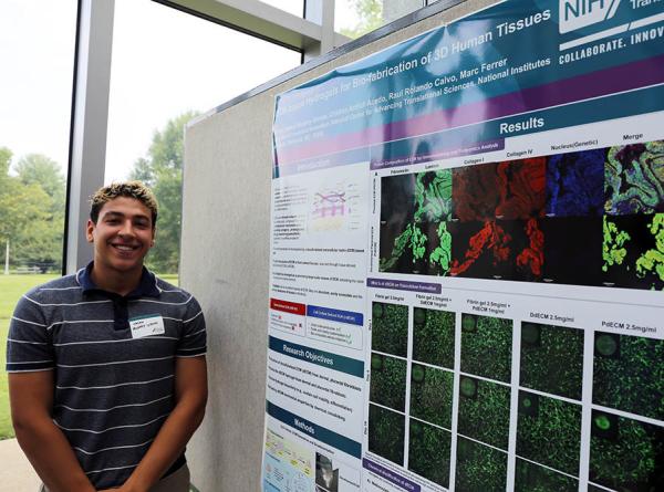 Nolan Murphy-Genao poses with his poster at Summer Poster Day