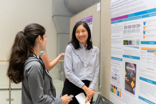 Doctor Zong explaining her poster