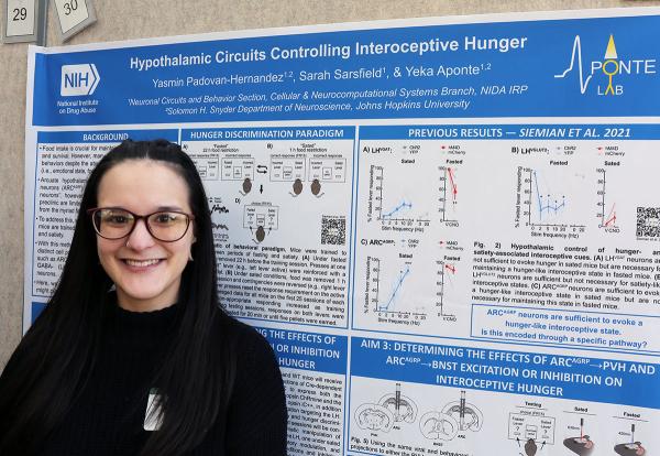 IRP graduate student Yasmin Padovan-Hernandez poses with her scientific poster