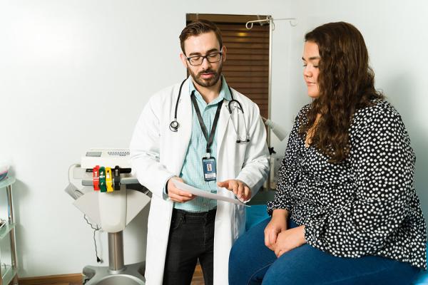 overweight patient talking with doctor