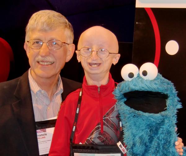 Dr. Collins poses with his friend Sam Berns, a young man with progeria, and Cookie Monster