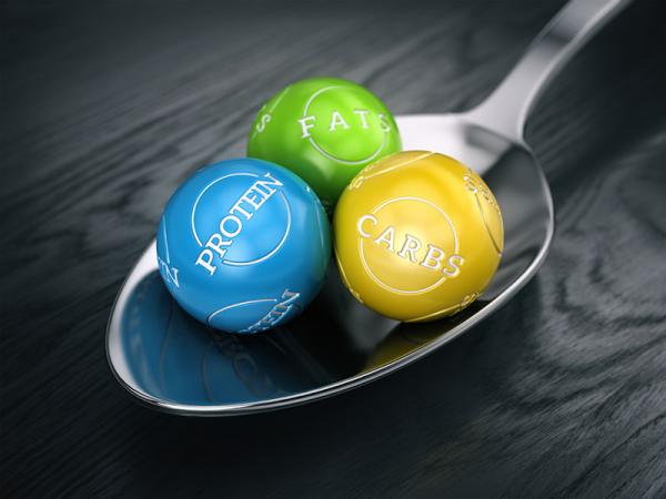 balls on a spoon representing the three types of macronutrients: carbs, fats, and protein