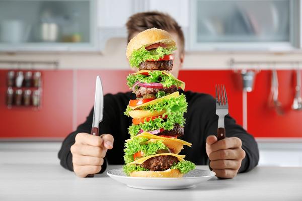 person eating an over-sized burger