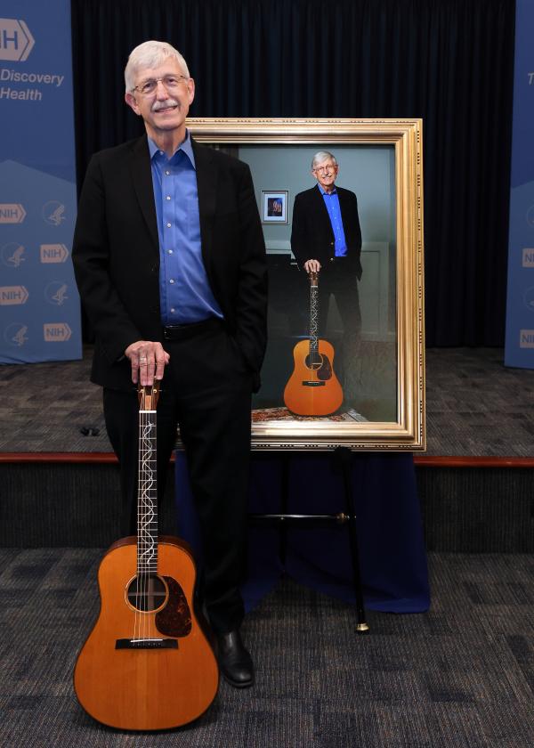 Francis Collins holding his guitar named Rosalind