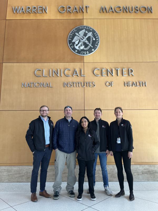 five people in the NIH Clinical Center atrium