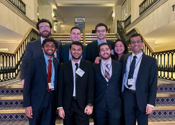 urology research fellows pose for a photo on a staircase