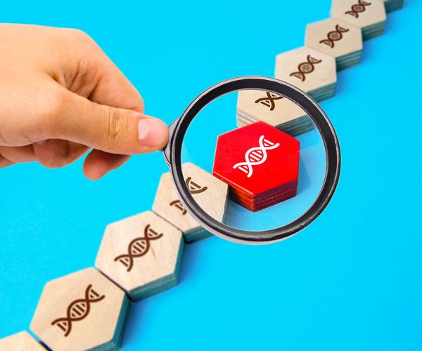 magnifying glass examining a DNA mutation