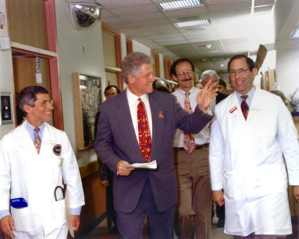 John Gallin walks with Anthony Fauci, Bill Clinton, and Harold Varmus