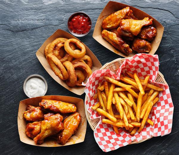 collection of food generally served at bars, including chicken wings, French fries, and onion rings