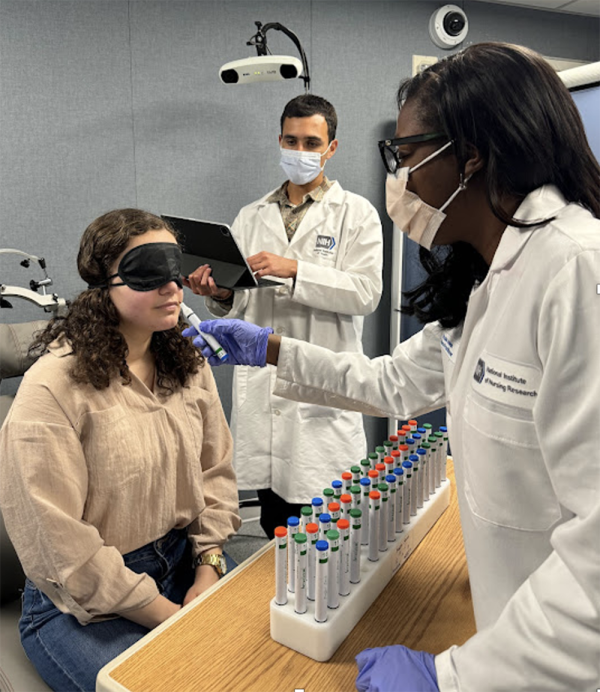 Dr. Paule Joseph (right) conducts a smell test with a study participant