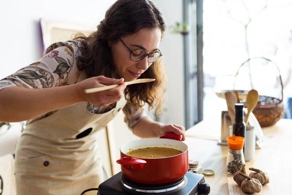 woman tasting soup